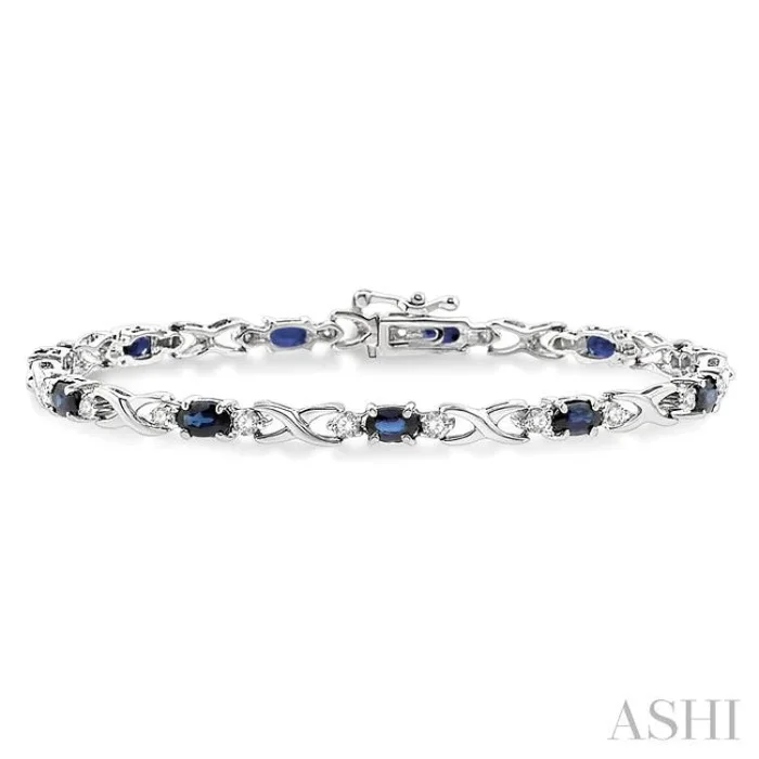 5×3 MM Oval Cut Sapphire and 1/10 Ctw Single Cut Diamond Bracelet in 10K White Gold
