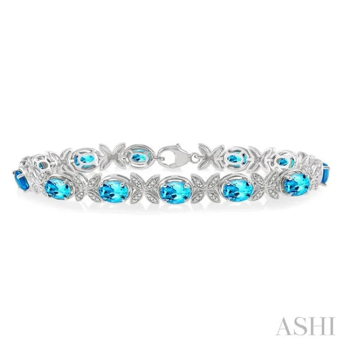 7×5 MM Oval Cut Blue Topaz and 1/10 Ctw Round Cut Diamond Semi-Precious Bracelet in Sterling Silver