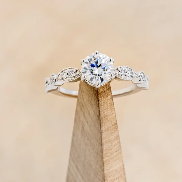 “ANISE” – ROUND CUT MOISSANITE ENGAGEMENT RING WITH DIAMOND ACCENTS