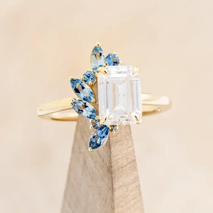 “ISABELLA” – EMERALD CUT MOISSANITE ENGAGEMENT RING WITH AQUAMARINE ACCENTS – 14K YELLOW GOLD – SIZE 5 3/4