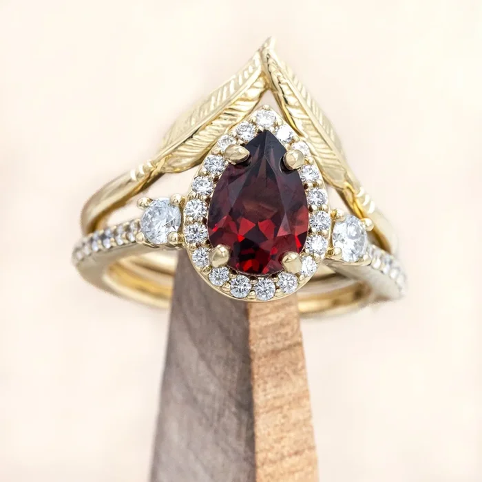 “KB” – PEAR CUT MOZAMBIQUE GARNET ENGAGEMENT RING WITH “FALA” TRACER