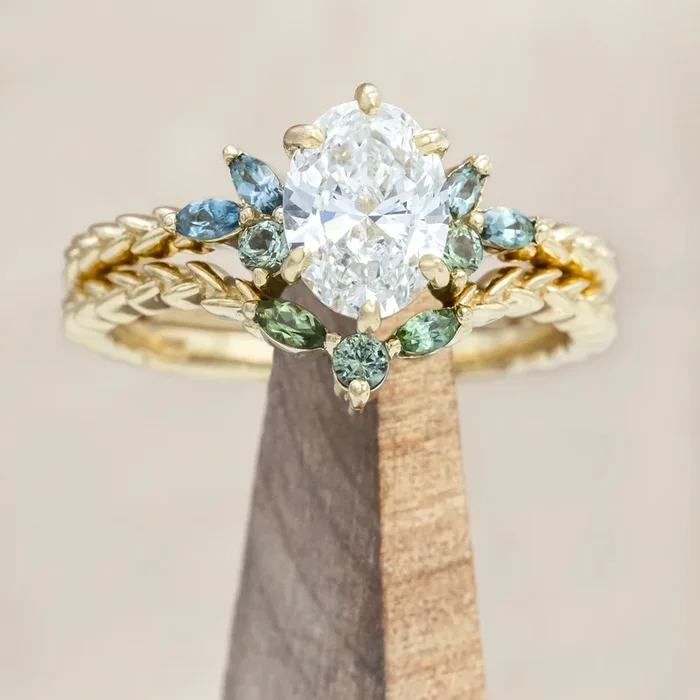 “LAUREL” – OVAL CUT LAB-GROWN DIAMOND ENGAGEMENT RING WITH TOURMALINE AND MONTANA SAPPHIRE ACCENTS, SHOWN WITH A CONTOURED TRACER
