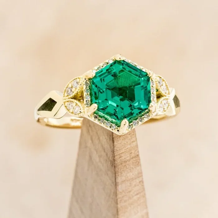“LUCY IN THE SKY” – HEXAGON CUT LAB GROWN EMERALD ENGAGEMENT RING WITH DIAMOND HALO & MOSS INLAYS