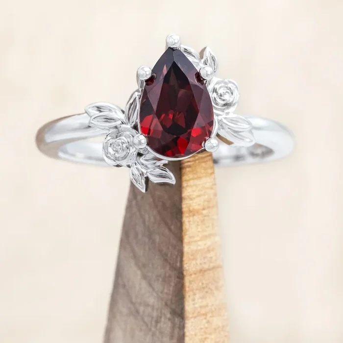 “ROSA” – PEAR CUT MOZAMBIQUE GARNET ENGAGEMENT RING WITH FLOWER ACCENTS – 14K WHITE GOLD – SIZE 7